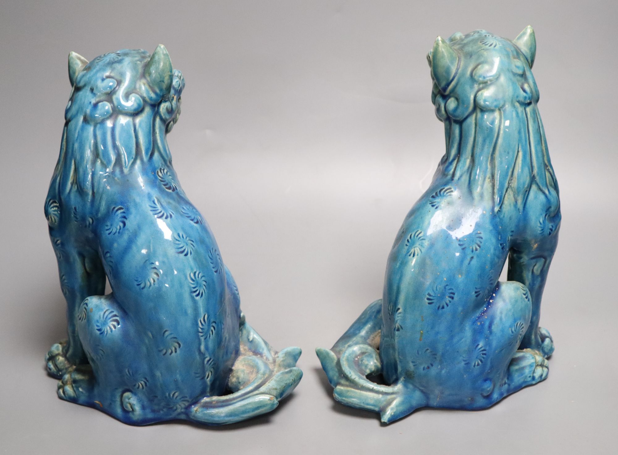 A pair of Japanese turquoise glazed pottery shi-shi, height 23cm